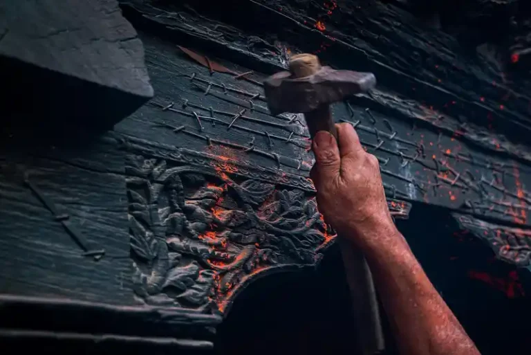 Man hammering a decorated wooden door during a Nepal cultural festival.