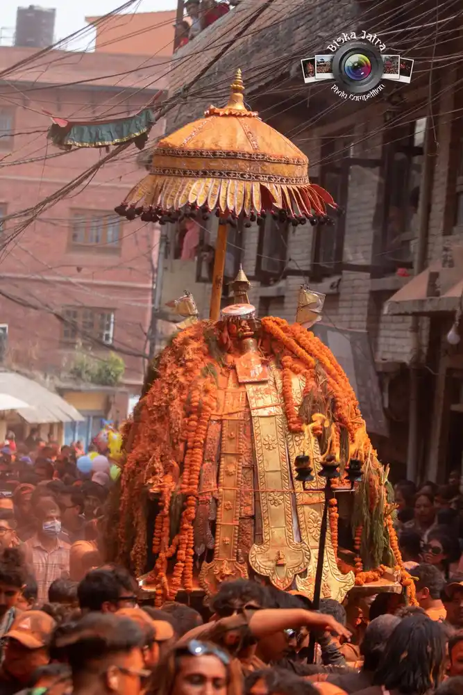Biska Jatra festival procession in Nepal, showing a decorated deity carried through the crowd.