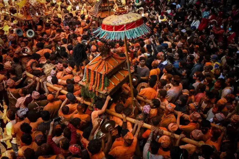 Crowd during a Nepal festival, featuring a decorated float in Thimi.
