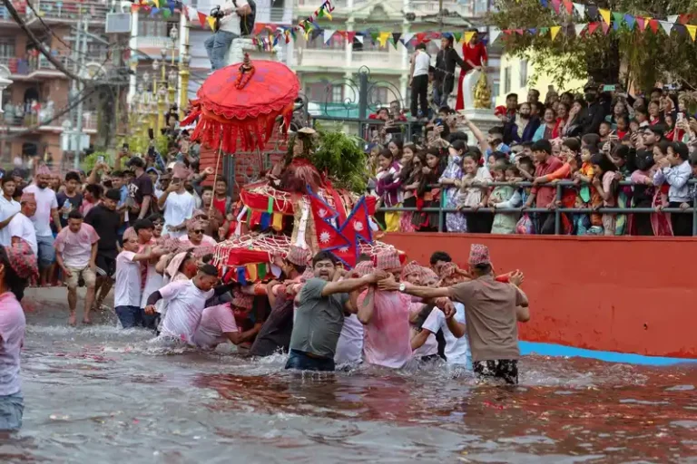 Devotees participate in the vibrant Biska Jatra festival, celebrating in the river of Nepal.