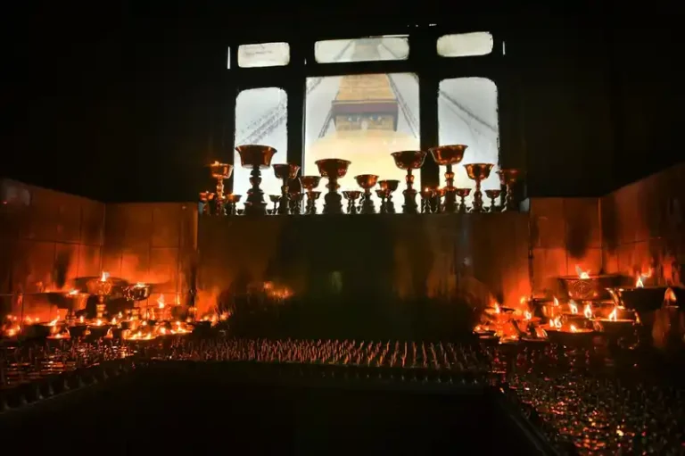 Lamps glow during Buddha Jayanti celebrations in Nepal, viewing the sacred temple structure.