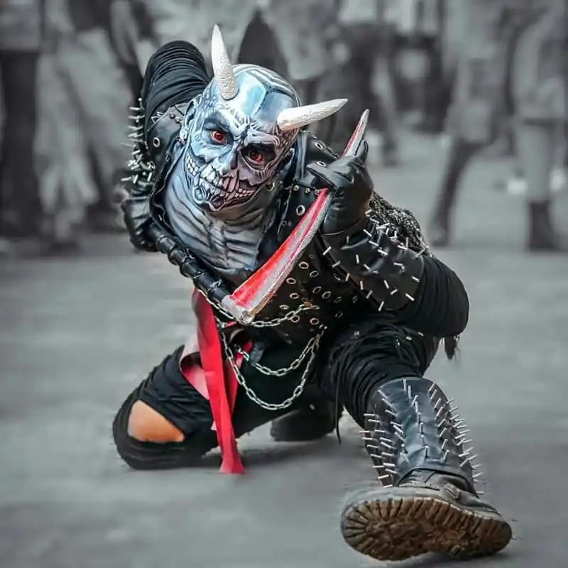 Masked figure participating in a Gai Jatra Nepal festival procession.