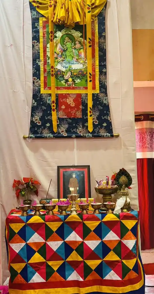 Display of religious artifacts and colorful textiles during a Nepal cultural or religious event.