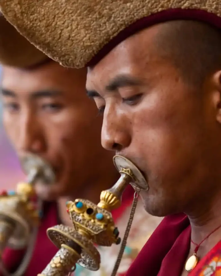 Musicians celebrating Nepal's Losar festival with traditional brass instruments.