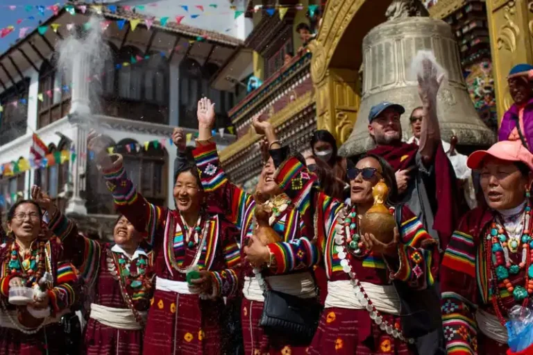 Joyful celebration during Losar festival in Nepal with traditional attire.