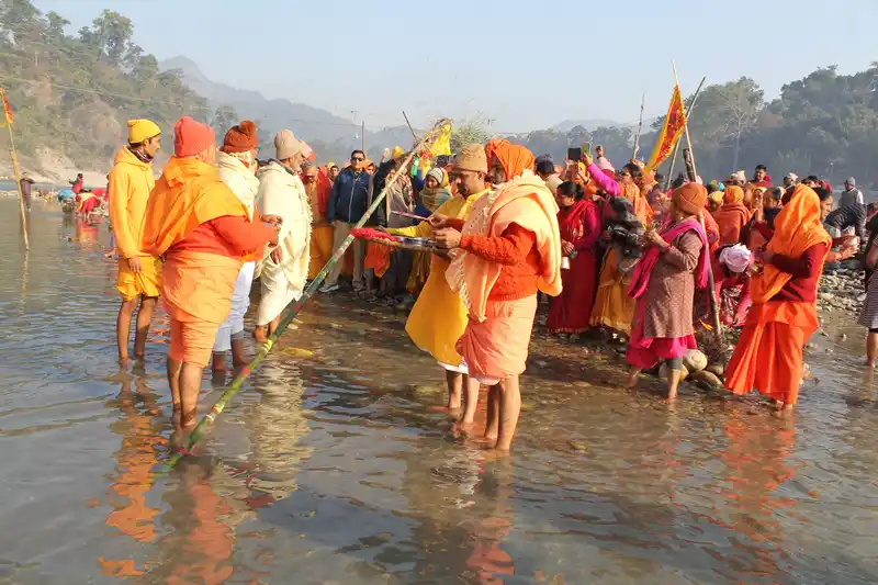 Devotees perform Maghe Sankranti rituals at Devghat, Nepal, gathering in the sacred river water.