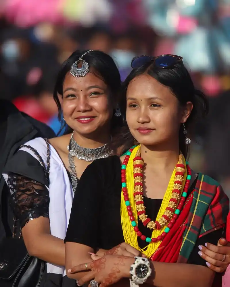 Nepali women celebrating Maghe Sankranti festival with traditional attire and vibrant jewelry.