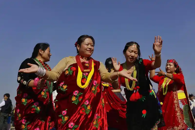 Magar women celebrating Maghe Sankranti festival in Nepal with vibrant traditional attire.