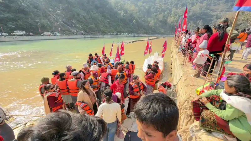 Crowd at a riverbank during a Nepal cultural or religious festival, possibly Maghe Sankranti.