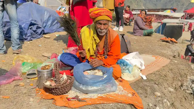 Man performing rituals at a Maghe Sankranti Mela in Nepal.