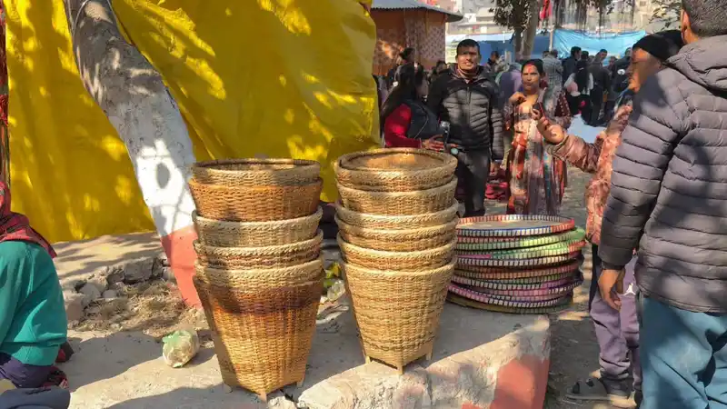 Vibrant market scene at the Maghe Sankranti Mela in Nepal, showcasing local crafts and community life.