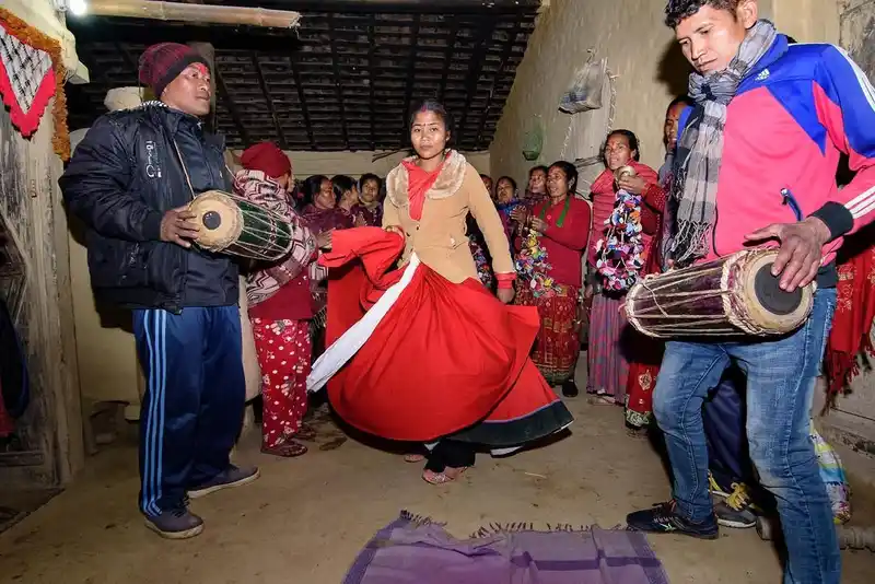 Tharu community celebrating Maghe Sankranti festival in Nepal with vibrant traditions and music.