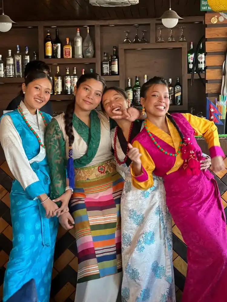 Joyful women in traditional Nepali dress celebrating Sonam Loshar festival.