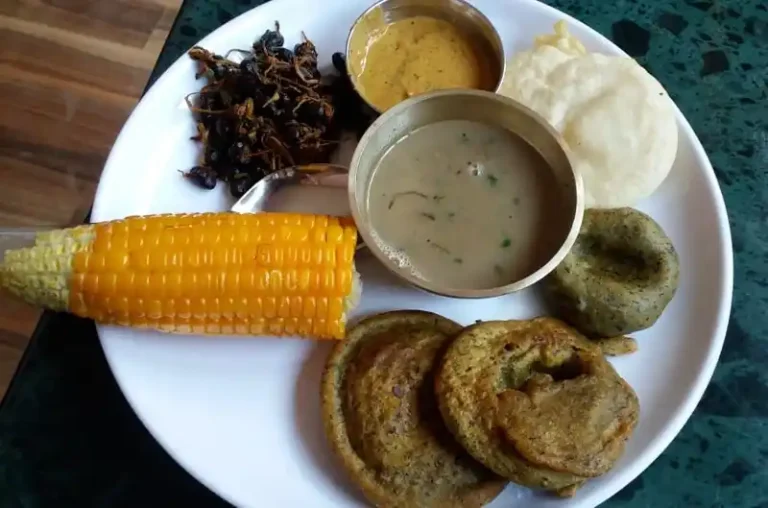 Assortment of Sonam Loshar Nepal food including corn, curry, and snacks.