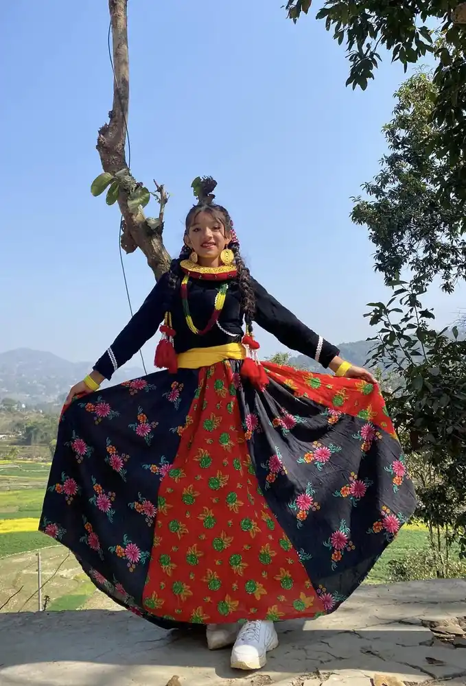 Nepali girl wearing vibrant traditional attire during a cultural festival.