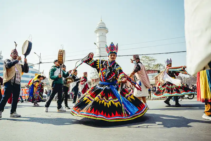 Dancers in vibrant traditional costumes perform during a Losar festival in Nepal.