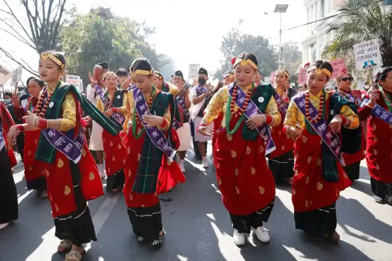 Vibrant procession of Nepali women celebrating a cultural festival in Nepal.