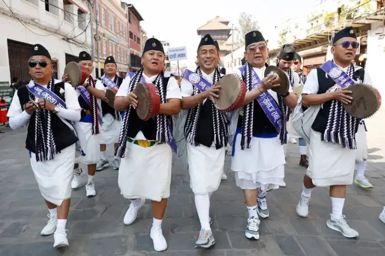 Nepali men in traditional attire during a vibrant cultural procession in Nepal.