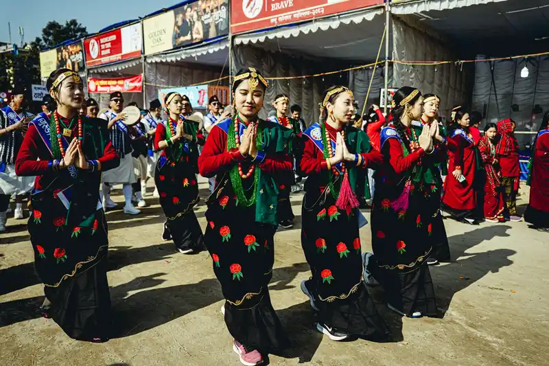 Nepali women celebrating Losar festival with traditional dance and prayers.