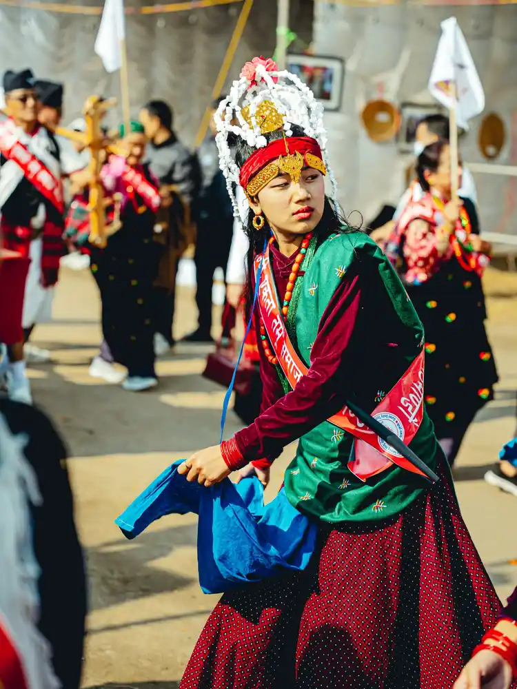 Woman celebrating Tamu Loshar festival in Nepal wearing vibrant traditional attire.