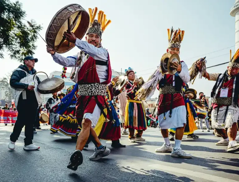 Dancers in traditional Nepali attire celebrate during a festival in Nepal.