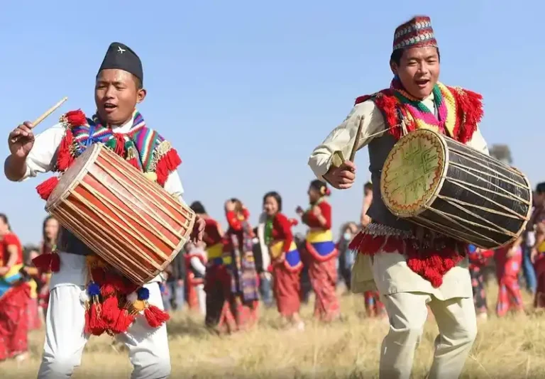 Kirat men playing drums during a cultural festival in Nepal.
