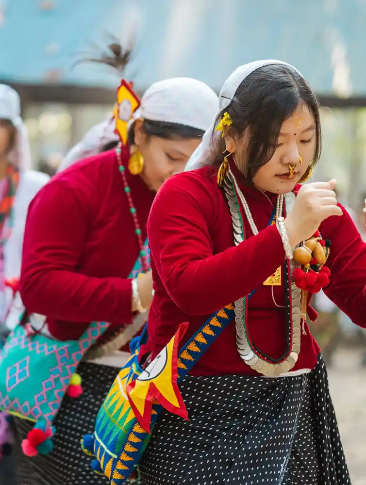 Kirat women celebrate Udhauli Parva in Nepal, wearing colorful traditional festival attire.