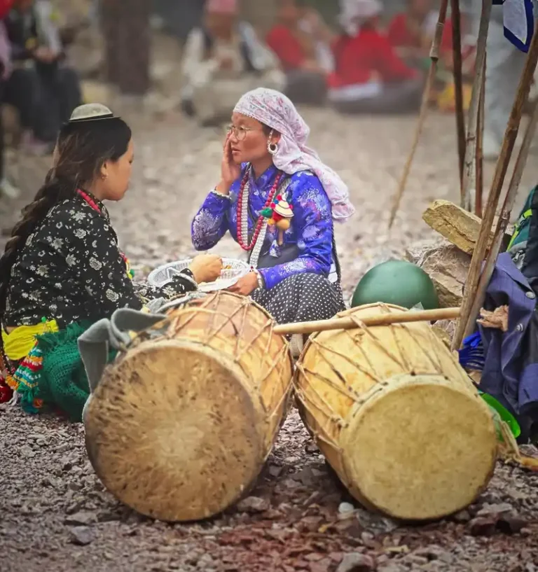 Kirat women at Udhauli Parva in Nepal, preparing drums for the cultural festival.